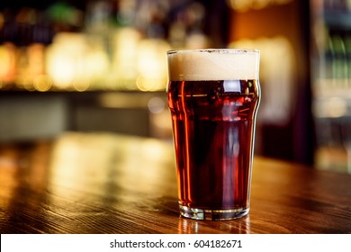 A Glass Of Dark Beer On Counter