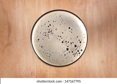 Glass Of Dark Beer On Table, Top View