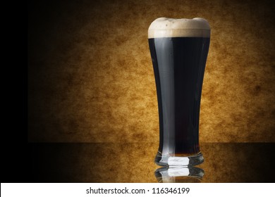Glass Of Dark Beer On Yellow Background