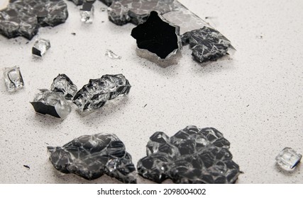 Glass Debris And Debris From The Explosion Of The Glass Panel Of The Stove Scattered On The Kitchen Table