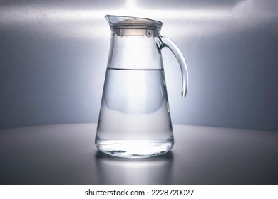 glass decanter filled with clean drinking water beautifully illuminated on gray background. Water advertising. Jug. Water is life. Space for text. CopySpace. no people. subject shooting - Shutterstock ID 2228720027