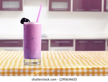 Glass Of Delicious Berry Cocktail On Perple Background