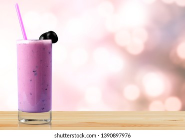 Glass Of Delicious Berry Cocktail On Perple Background