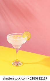 Glass Of Delicious Margarita Cocktail Isolated Over Pink Yellow Background. Popular Taste. Party Time. Concept Of Cocktails, Alcoholic Drinks, Taste, Party, Mix. Copy Space For Ad. Retro Style