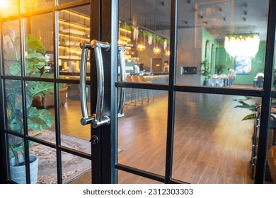 Glass door at the entrance of the coffee shop. - Powered by Shutterstock