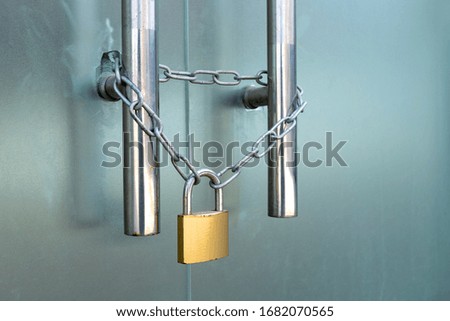 The glass door was locked with padlocks and chains