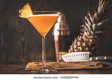 Glass Of Downhill Racer Cocktail Garnished With Pineapple Wedge