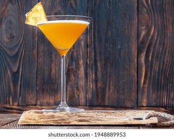 Glass Of Downhill Racer Cocktail Garnished With Pineapple Wedge