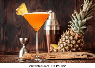 Glass Of Downhill Racer Cocktail Garnished With Pineapple Wedge