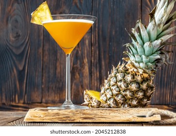 Glass Of Downhill Racer Cocktail Garnished With Pineapple Wedge