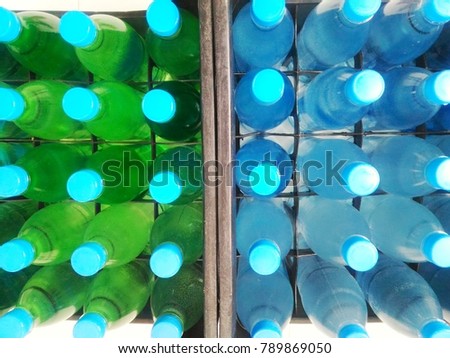 Glass drink bottle box for transport. drinking water background, clean water.Water drink on sale Green and bright bottle plastic. 
