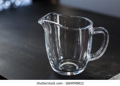 Glass Empty Milk Jug On Black Background