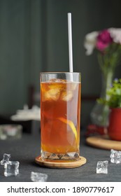 Glass Of Espresso With Lemon Juice And Fresh Sliced Lemon On Wooden Table And Copy Space, Summer Cocktail, Cold Brew Coffee Or Black Tea. (close Up, Selective Focus)