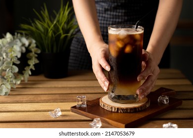 Glass Of Espresso With Lemon Juice On Wooden Table And Copy Space, Summer Cocktail, Cold Brew Coffee Or Black Tea. (close Up, Selective Focus), Pouring Cold Drink.