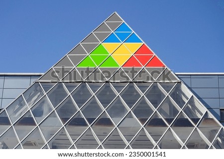 The glass facade of the building in the form of a pyramid