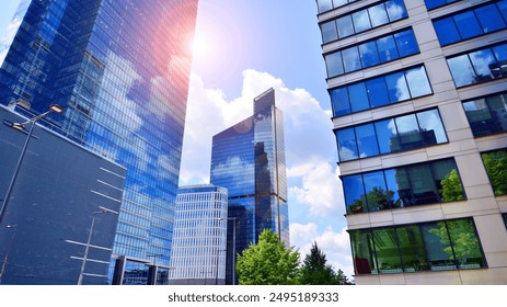 Glass facade of the buildings with a blue sky. Skyscrapers in the business city center.. Background of modern glass buildings. 