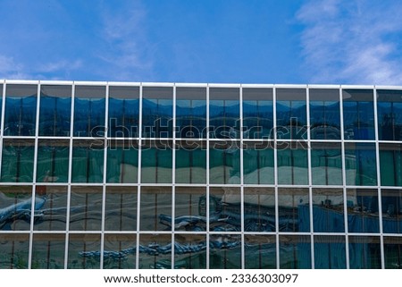 Glass facade with geometric pattern of modern office tower at Zürich Kloten Airport on a sunny summer day. Photo taken July 23rd, 2023, Zurich, Switzerland.