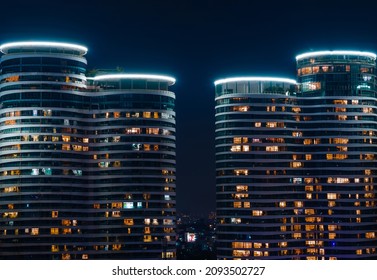 Glass facade of modern city high rise, buildings show lighting using by human activity, energy usage at night time. Glowing windows of skyscrapers at night. Location Ho Chi Minh city, Vietnam. - Powered by Shutterstock