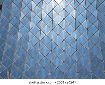 glass facade pattern of squares and triangles