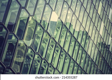 Glass facade with reflection of abstract building