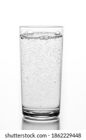 A Glass Filled With Sparkling Water. A Container For Storing Liquids. Light Background.