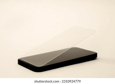 glass film change,repair and maintenance smartphone.hand in glove holding screen protection.flying in air tempered glass and phone.tools and display napkin - Powered by Shutterstock