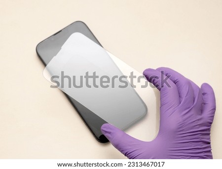 glass film change,repair and maintenance smartphone.hand in glove holding screen protection.flying in air tempered glass and phone.medical stethoscope meaning mobile doctor.tools and display napkin