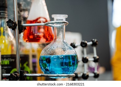 Glass Flask With A Blue Composition In A Chemical Laboratory, The Study Of The Interaction Of Various Petrochemical Elements, Science At The University. High Quality Photo