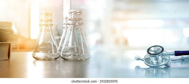 Glass Flask With Text Book And Doctor Stethoscope In Medical Health Science Lab Banner Background