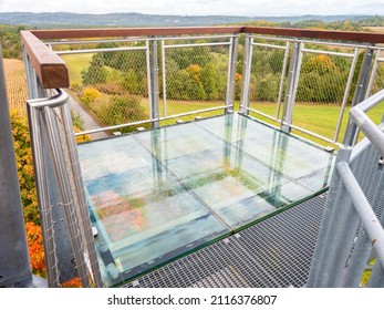 Glass floor on glass balcony of view tower. Amazing view to far landscape. Autumn colors. Malobratrice, Czechia