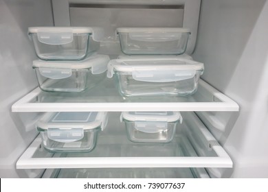 Glass Food Containers With White Plastic Lid In New Open Refrigerator.