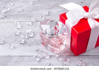 Glass Fragrant Perfume Bottle With Red Gift Box. Mixed Pieces Of Ice With A Bag