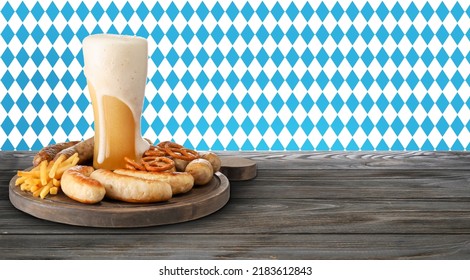Glass of fresh beer and snacks on wooden table. Oktoberfest celebration