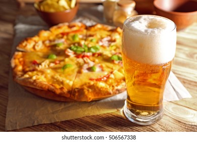 Glass of fresh beer and tasty pizza on background - Powered by Shutterstock