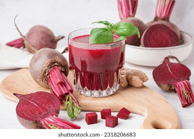 Glass of fresh beetroot juice with vegetables on light background - Powered by Shutterstock