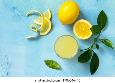 Glass Of Fresh Freshly Squeezed Lemon Juice On A Turquoise Stone Or Concrete Table. Top View Flat Lay Background. 