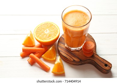 Glass with fresh juice  and ingredients on wooden table