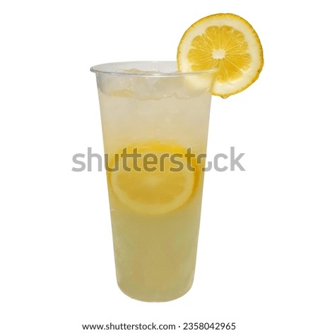 Glass of fresh lemonade in a clear tall plastic cup isolated on white background with clipping path. Cool freshly made lemonade and lemon slices. To-go cold beverages menu. No label mockup template.