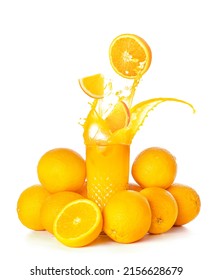 Glass of fresh orange juice with splashes and many fruit on white background