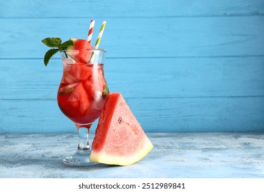 Glass of fresh watermelon lemonade with mint on blue table - Powered by Shutterstock