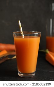 Glass Of Freshly Made Carrot Juice On Black Table