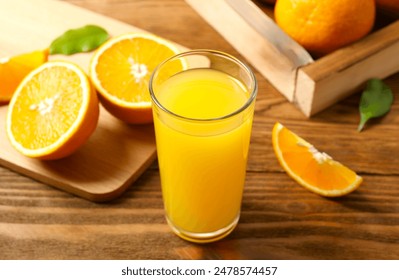 Glass of freshly squeezed orange juice on the table with citrus fruits - Powered by Shutterstock