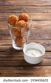 A Glass Of Fried Cheese Balls And Ranch Sauce On A Wooden Table