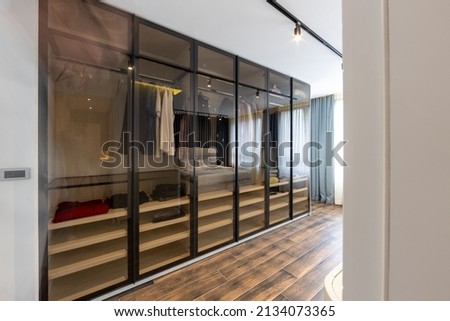 Glass fronted, see through closet in modern apartment