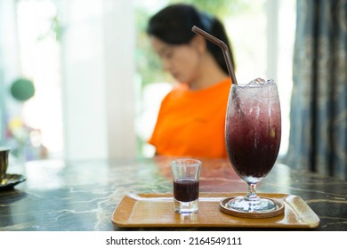 A Glass Of Fruit Juice Made From Mulberry Blur Girl At The Background In The Drink Shop