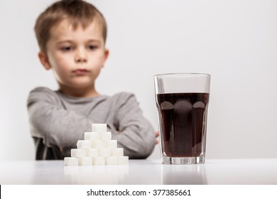 Glass Full Of Soft Drink, Next To It Is The Amount Of Sugar Used In It. Modern Day To Day Diet, Young People Drinking To Many Soft Drinks, Everyday Sugar Usage Among Children Concept Photo.