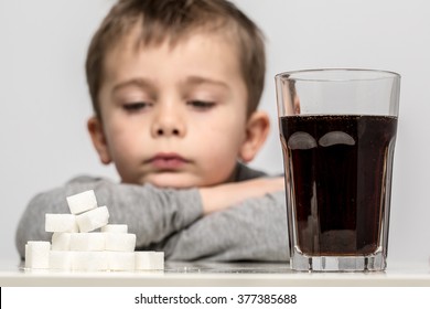 Glass Full Of Soft Drink, Next To It Is The Amount Of Sugar Used In It. Modern Day To Day Diet, Young People Drinking To Many Soft Drinks, Everyday Sugar Usage Among Children Concept Photo.