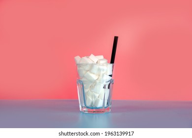 Glass Full With Sugar Cubes With Straw On Pastel Pink And Blue Background With Copy Space, Retro Design, Sweets,candy,soda,unhealthy Eating Concept. Modern Design Colorful