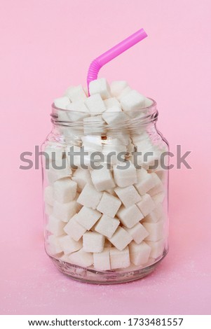 Glass full of sugar cubes - unhealthy diet concept.