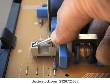 Glass fuse on an electrical circuit. Cartridge fuse on circuit board. - Shutterstock ID 2328725633